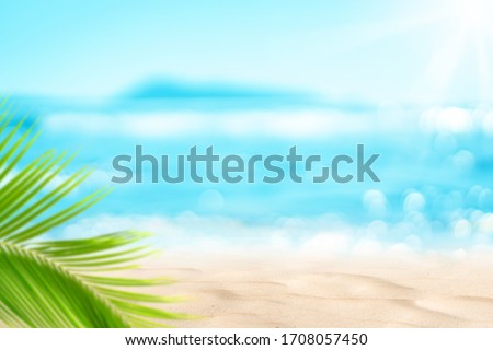 Blur beautiful nature green palm leaf on tropical beach with bokeh sun light wave abstract background. Copy space of summer vacation and business travel concept. Vintage tone filter effect color style Royalty-Free Stock Photo #1708057450