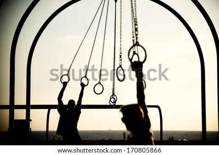 Tourists swinging on rings on the beach, Santa Monica Beach, Santa Monica, Los Angeles County, California, USA