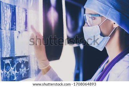 Two female women medical doctors looking at x-rays in a hospital. Royalty-Free Stock Photo #1708064893