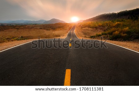 Picturesque landscape scene  ,long straight road leading towards a mountain and sunset at skyline. Royalty-Free Stock Photo #1708111381