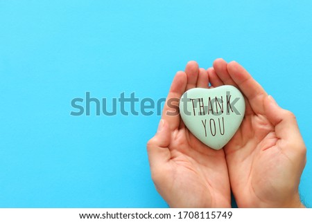 top view image holding heart with the text thank you