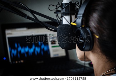 young women dj works in broadcast studio