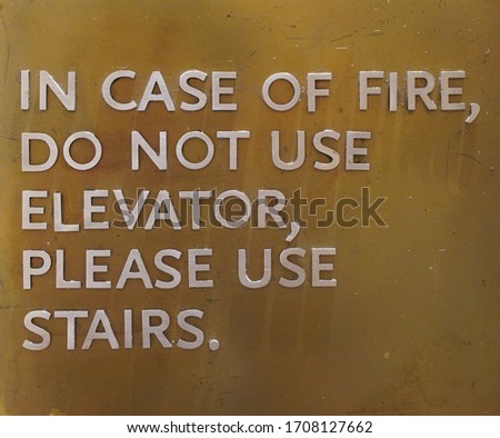 A sign that says, In Case Of Fire, Do Not Use Elevator, Please Use Stairs, which direct people of what to do in case of an fire emergency.