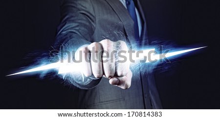 Businessman holding lightning in fist. Power and control Royalty-Free Stock Photo #170814383