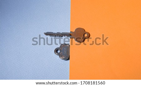 Two silver keys on background