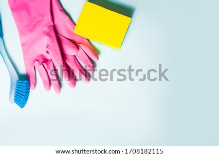 cleaning attributes, gloves, sponge brush, items for washing, top view on a blue background, for text