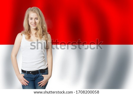 Happy cute woman with Monaco flag banner