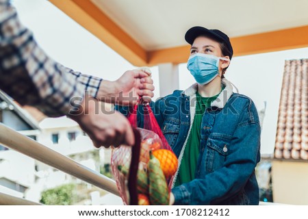 Teenage girl is delivering some groceries to an elderly person. Royalty-Free Stock Photo #1708212412