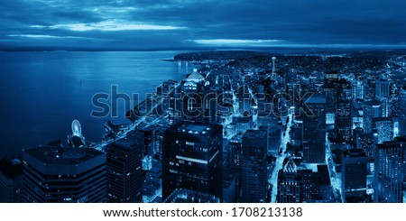 Seattle rooftop panorama view with urban architecture at night.