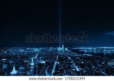 New York City downtown skyline view at night with September 11 tribute light.