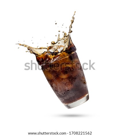 Studio shooting Cola splashing out of a glass.Cola in glass with splash of ice isolated on white background with clipping path