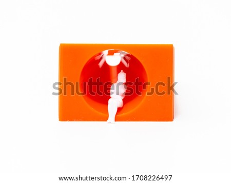 lonely girl doll with an orange background in a spiral