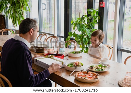 Family of two having a celebration in a cafe