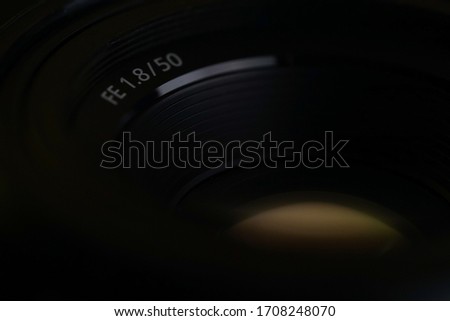 big closeup lens 50mm / 1.8 black on a dark background