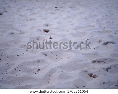 Sand and small stones on the beach.