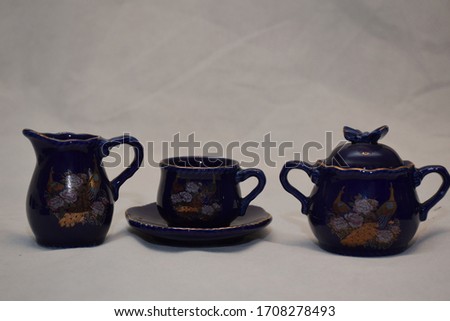 Mock up / design set of elegant and traditional teapot colorful white blue gold coffee cup & Tea cup on cup's plate beside the hot tea pot , design/ drink-ware isolated on white background