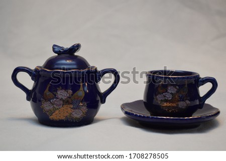 Mock up design set of elegant and traditional teapot colorful white blue gold coffee cup & Tea cup on cup's plate beside the hot tea pot , design drink-ware isolated on white background