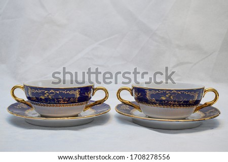 Mock up design set of elegant and traditional teapot colorful white blue gold coffee cup & Tea cup on cup's plate beside the hot tea pot , design drink-ware isolated on white background
