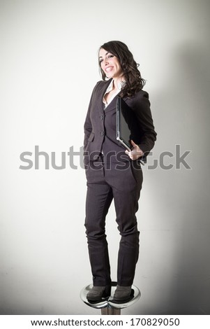 beautiful young businesswoman on gray background