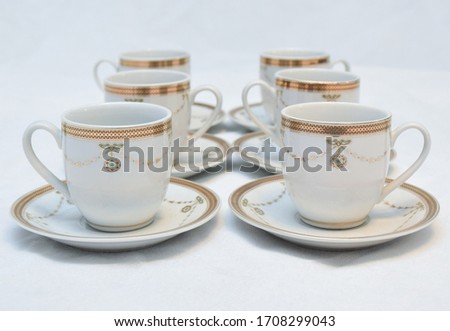 Mock up / design set of elegant and traditional teapot colorful white and Gold coffee cup & Tea cup on cup's plate beside the hot tea pot , design/ drink-ware isolated on white background