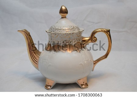 Mock up / design set of elegant and traditional teapot colorful white and Gold coffee cup & Tea cup on cup's plate beside the hot tea pot , design/ drink-ware isolated on white background