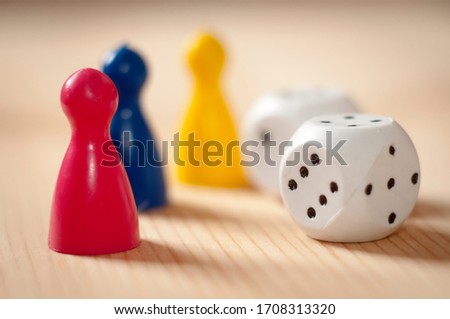 Playing dice and chips on a wooden surface close up