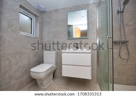 Contempoarary Fully tiled simple WC and Shower Design London UK
