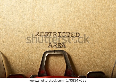 Restricted area text written on a paper.