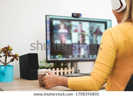 Young woman having a discussion meeting in video call with her team - Girl having chatting with friends on computer web app - Technology and smart work concept - Focus on hand
