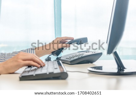 Female working, hands using computer telephone, closeup Royalty-Free Stock Photo #1708402651