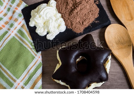 Chocolate star and cream on a table