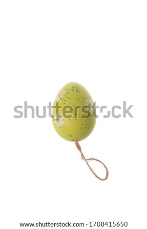 Yellow decorative eater egg with flowers and spots, isolated on white background