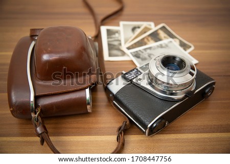 close-up, antique film camera and photo print standing on wooden floor