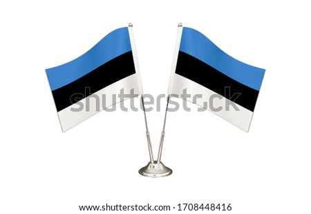 Estonia table flag isolated on white ground. Two flag poles with flags and Estonia flag on the table.