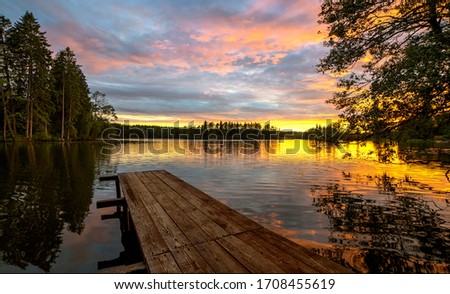 Wooden bridge on the lake in the distance sunset. Royalty-Free Stock Photo #1708455619