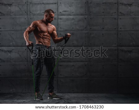 Muscular Athletic Men Exercise With Resistance Band. Copy Space Royalty-Free Stock Photo #1708463230