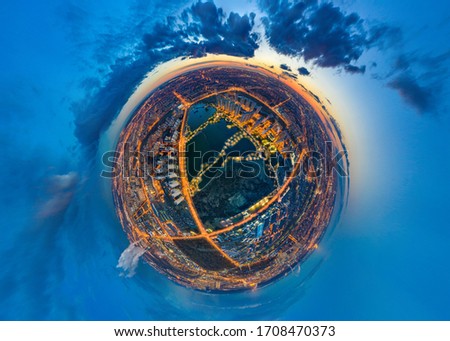 Aerial photography of the city. Evening city as a planet. Night illumination of the planet Earth. The urban area is perceived as a separate planet. Life in the Universe. The city from a drone.