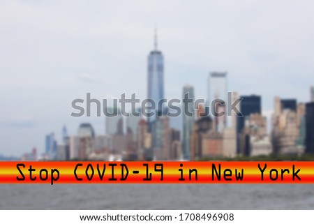 a futuristic stop covid-19 red banner over a blurred skyline of New York
