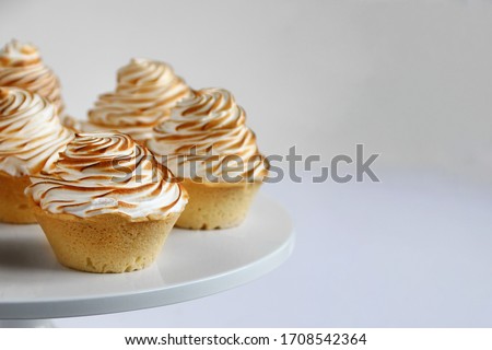 lemon meringue tart closeup on white background. lemon curd tart. tasty lemon mini meringue pie