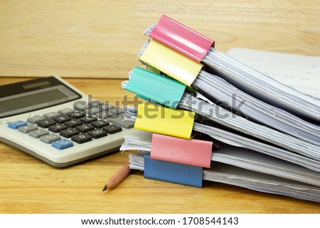 file folder and Stack of business report paper file with 
Calculator on the table in a work office, concept document in work office