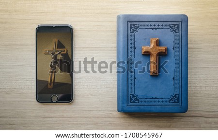 Worship from home, Online live church for good friday service, Top view of mobile screen with wooden cross photo and bible with, quarantine for Covid 19 situation