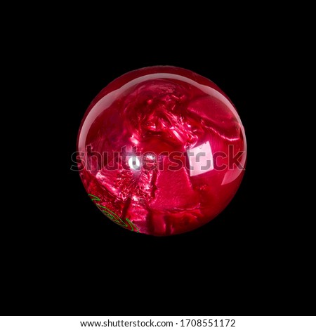 Bowling ball red. Isolated on a black background close-up.