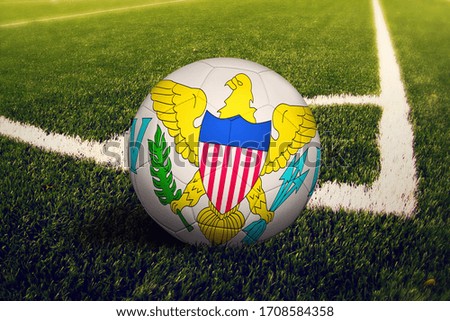 United States Virgin Islands flag on ball at corner kick position, soccer field background. National football theme on green grass.