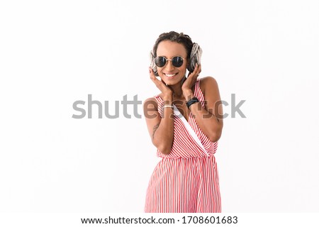 Image of a smiling optimistic young cute cheery african woman with dreads posing isolated over white wall background.