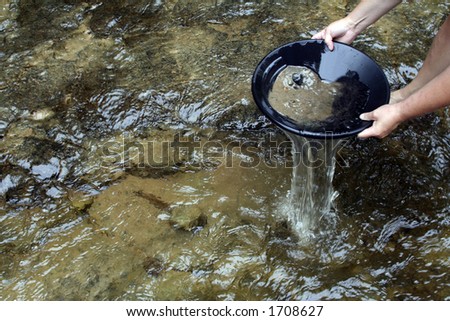 Panning for gold in a northern michigan stream Royalty-Free Stock Photo #1708627