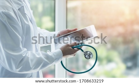 Telemedicine by medical doctor or physician consulting patient’s health telehealth online using mobile tablet in clinic or hospital for professional digital emergency healthcare assistance service Royalty-Free Stock Photo #1708633219