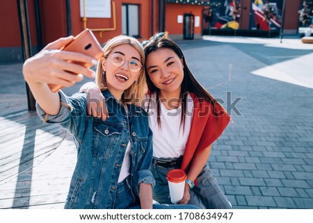 Portrait of happy female users connecting to 4g wireless for making selfie content and share to social website, millennial diverse hipster girls 20 years old smiling at camera while shooting video