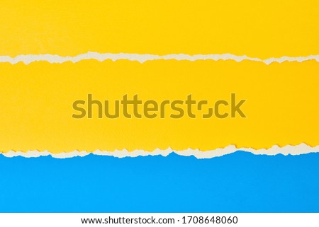 Torn ripped paper edge with copy space, color blue and yellow background