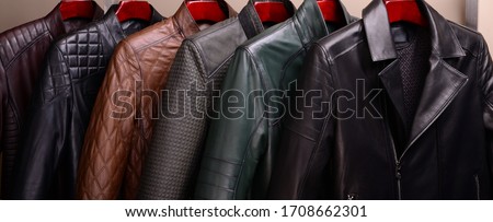 New collection of different color spring leather jackets for men. Colorful background of modern spring, autumn outerwear. Close up. Seasonal clothing in store on sale. Royalty-Free Stock Photo #1708662301