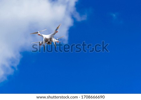 Quadrocopter flying in the sky. Modern dron in the air with camera.
